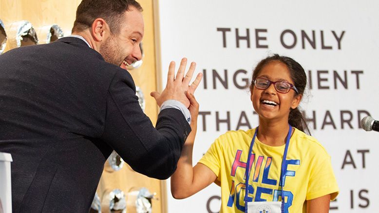 Host high fives young girl contestant