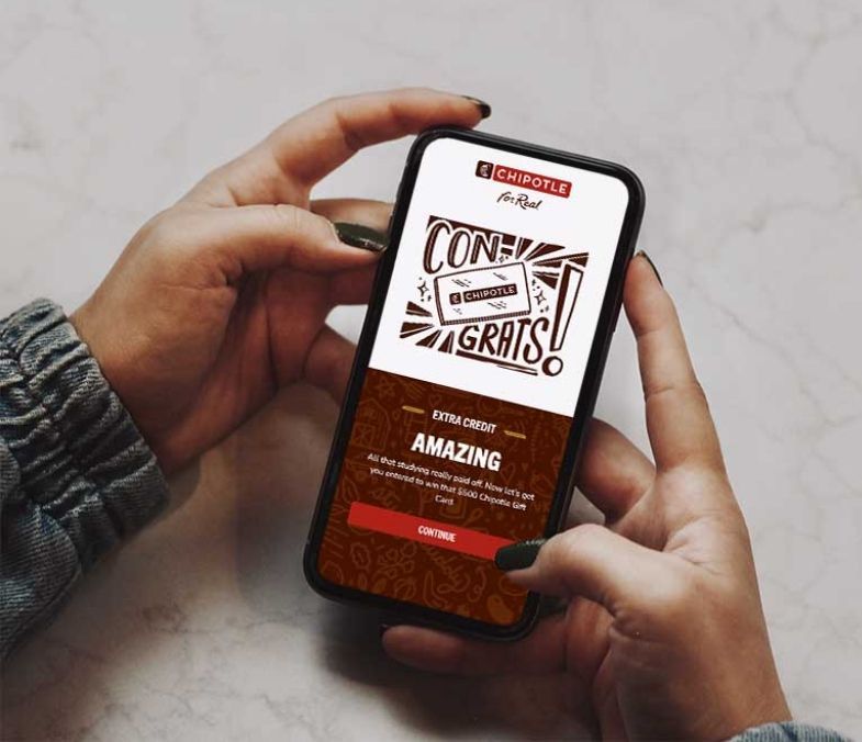 User holding phone with congratulations screen